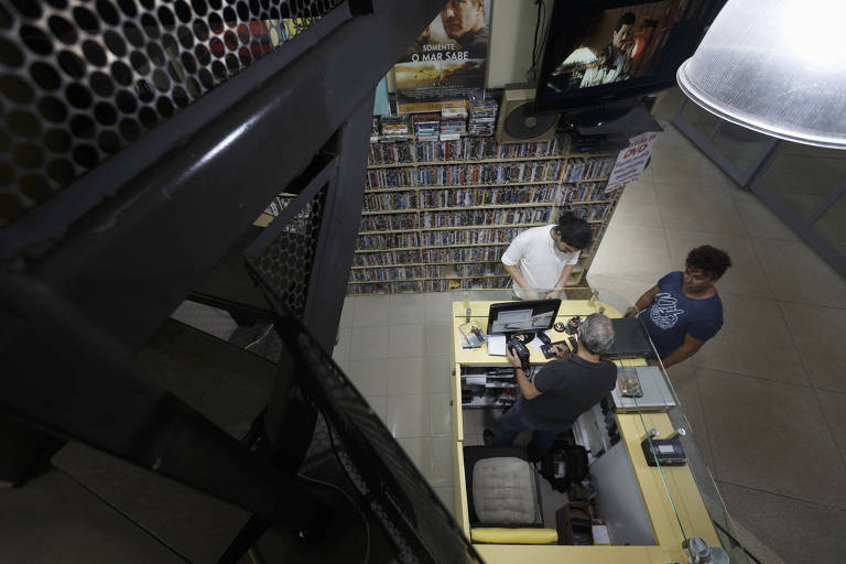 Paulo Pereira atente clientes na sua locadora, no edifício Copam, no centro de São Paulo