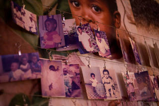 Pictures of victims donated by survivors hang on a wall inside the Genocide Memorial in Gisozi within Kigali