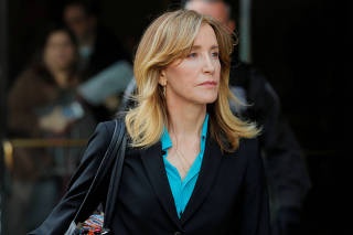 FILE PHOTO: Actor Felicity Huffman, facing charges in a nationwide college admissions cheating scheme, leave federal court in Boston