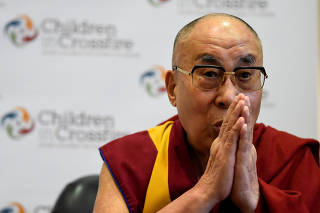 FILE PHOTO: Tibetan spiritual leader the Dalai Lama, Patron of Children in Crossfire, gestures during a press conference in Londonderry