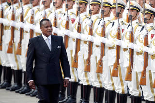 Congo Republic President Denis Sassou Nguesso reviews honour guards during a welcoming ceremony in Beijing