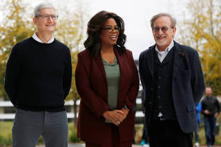 CEO Tim Cook, Oprah Winfrey and director Steven Spielberg stand for a photo after the Apple special event at the Steve Jobs Theater in Cupertino, California