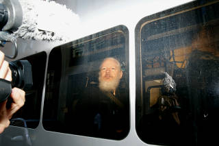 WikiLeaks founder Julian Assange is seen in a police van, after he was arrested by British police, in London