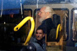 WikiLeaks founder Julian Assange is seen in a police van in London