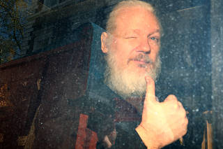 WikiLeaks founder Julian Assange arrives at the Westminster Magistrates Court, after he was arrested  in London