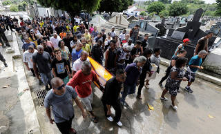 People carry the coffin containing the body of Evaldo Rosa dos Santos, who was killed during a military operation, during Santos' funeral in Rio de Janeiro