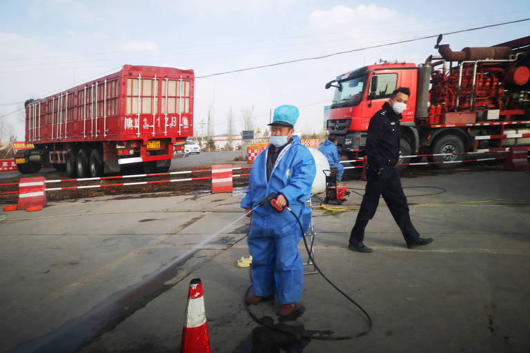 Desinfecção de veículos perto de fazenda na China em que foi detectado foco de peste suína africana