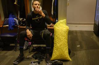 The Golden State Warriors star Steph Curry indulges in his serious, serious popcorn habit at the Smoothie King Center in New Orleans.