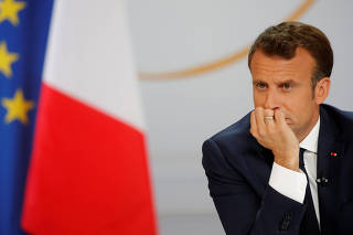 French President Emmanuel Macron listens to a question during a news conference to unveil his policy response to the yellow vests protest, at the Elysee Palace in Paris