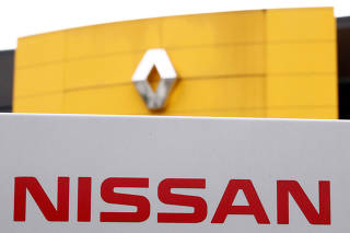 FILE PHOTO: The logos of car manufacturers Renault and Nissan are seen in front of a common dealership of the companies in Saint-Avold