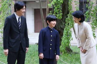 Prince Hisahito talks with his parents Prince Akishino and Princess Kiko at Ochanomizu University junior high school before attending the entrance ceremony in Tokyo
