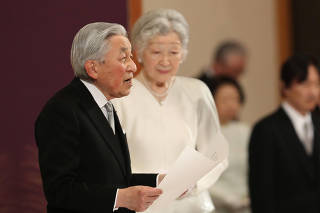 Japan's Emperor Akihito, flanked by Empress Michiko, delivers a speech during a ritual called Taiirei-Seiden-no-gi, a ceremony for the Emperor's abdication, at the Imperial Palace in Tokyo