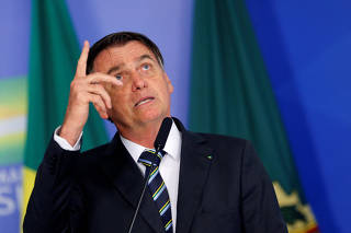 Brazil's President Jair Bolsonaro gestures while speaking during a ceremony at the Planalto Palace in Brasilia