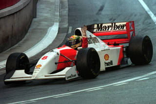 FILE PHOTO: Senna of Brazil in his McLaren Ford raises his hand after winning the 1993 Monaco Grand Prix