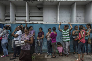 Hundreds wait of people exhibiting symptoms of malaria wait outside a small clinic in Ciudad Guayana, Venezuela.