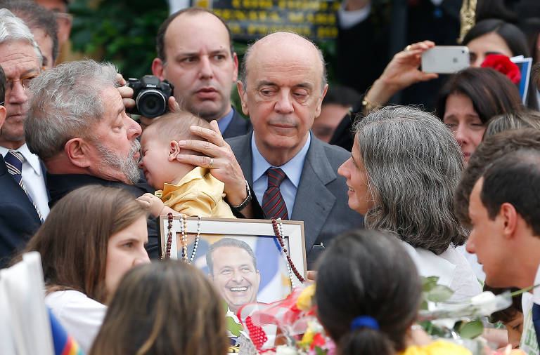 José Serra, então candidato ao Senado, acompanha funeral de Eduardo Campos, que era candidato pelo PSB à presidência da República e morreu em um desastre aéreo em Santos (SP). Outros políticos, como o ex-presidente Lula, também participaram das homenagens