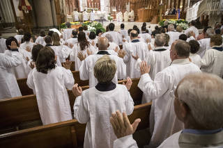 Catechumens, people converting to Catholicism, during an Easter vigil Mass at the Cathedral Basilica of the Sacred Heart in Newark, N.J.,
