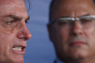 Brazilian President Jair Bolsonaro  talks with media as Rio de Janeiro's Governor Wilson Witzel observes, after attending a ceremony to celebrate the Victory Day marking the Allied Forces' victory in World War Two in Rio de Janeiro