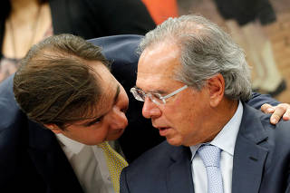 Brazil's Lower House President Rodrigo Maia talks with Brazil's Economy Minister Paulo Guedes during a session of the commission of the pension reform bill at the National Congress in Brasilia