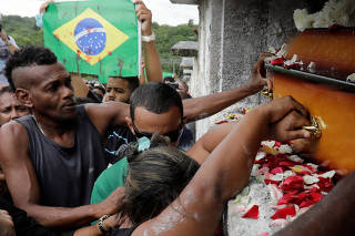 Luciana Nogueira, widow of Evaldo Rosa dos Santos, who was killed during a military operation, reacts during Santos' funeral in Rio de Janeiro