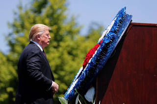 President Trump stands in front of wreath at National Peace Officers Memorial Service on Capitol Hill in Washington