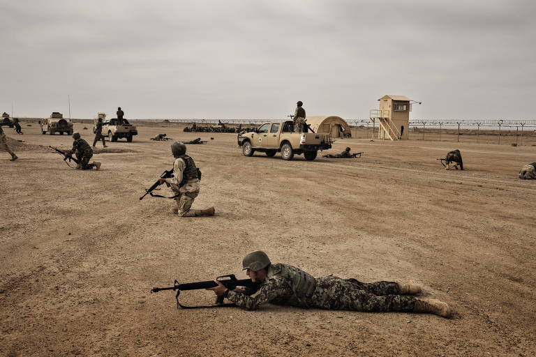 FILE -- Afghan National Army soldiers train under American supervision at Camp Bastion in Afghanistan's Helmand Province, March 22, 2016. For a third time, Taliban fighters infiltrated Camp Bastion, killing 23 Afghan soldiers and base workers on March 1, 2019, and the American military would once again have to come to the rescue of a base it had long since handed over. (Adam Ferguson/The New York Times)