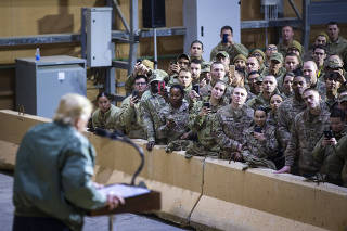 President Donald Trump addresses troops during a surprise visit to at Al Asad Air Base in Iraq.