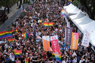 Same-sex marriage supporters celebrate after Taiwan became the first place in Asia to legalize same-sex marriage, outside the Legislative Yuan in Taipei