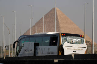 FILE PHOTO: A damaged bus is seen at the site of a blast near a new museum being built close to the Giza pyramids in Cairo