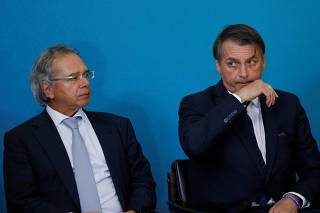 Brazil's President Jair Bolsonaro and Economy Minister Paulo Guedes attend a ceremony for the presentation of the 2nd phase of the advertising campaign of the pension reform bill at the Planalto Palace in Brasilia