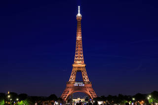 The Eiffel tower is illuminated during a light show to celebrate its 130th anniversary in Paris