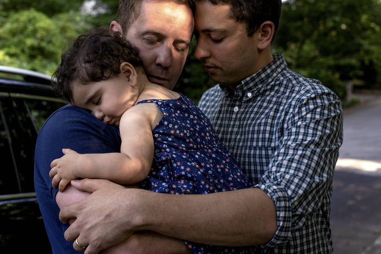 James Derek Mize, left, and his husband, Jonathan Gregg, with their infant daughter Simone, who was born in England to a surrogate mother, in Decatur, Ga., May 15, 2019. Under a decades-old policy that has come under increasing scrutiny, Simone does not qualify for citizenship at birth, even though both her parents are American. (Johnathon Kelso/The New York Times)