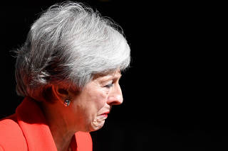 British Prime Minister Theresa May reacts as she delivers a statement in London
