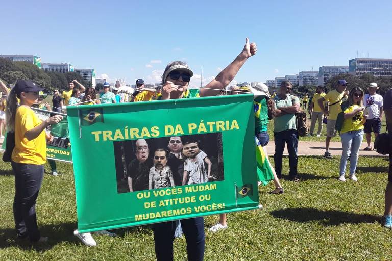Manifestante em Brasília exibe cartaz que chama de