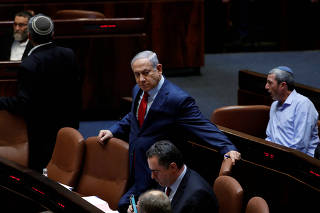 Israeli Prime Minister Benjamin Netanyahu arrives to the plenum at the Knesset, Israel's parliament, in Jerusalem