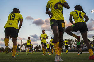 Members of Jamaica's national women's soccer team, the Reggae Girlz, warm up before an exhibition game, in Miramar, Fla.