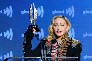FILE PHOTO: Singer Madonna holds up her Advocate for Change award during the 30th annual GLAAD awards ceremony in New York City