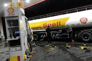 Oil tank truck fills the pumps at a Shell petrol station in Sao Paulo