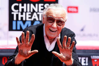 FILE PHOTO: Marvel Comics co-creator Lee shows his hands after placing them in cement during a ceremony in the forecourt of the TCL Chinese theatre in Los Angeles