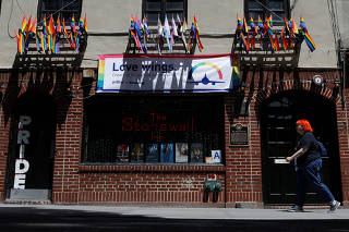 Woman walks past the Stonewall Inn, site of the 1969 Stonewall uprising in New York