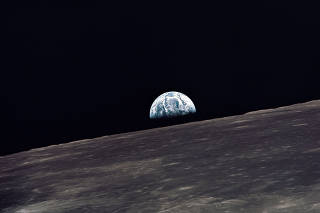 Earth rises above the lunar horizon during the Apollo 10 mission