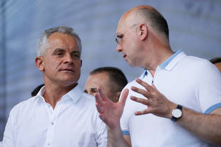 Moldovan interim president Pavel Filip and leader of the Democratic Party of Moldova Vladimir Plahotniuc attend a rally in Chisinau