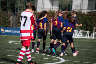 The Barcelona under-12 girls team celebrates a goal Sporting Gava in Barcelona, Spain