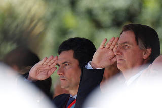 Brazil's President Jair Bolsonaro and Brazil's Justice Minister Sergio Moro gesture during a ceremony of the 154th anniversary of the Riachuelo Naval Battle at the Marine Corps Headquarters in Brasilia
