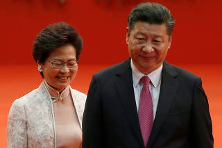 FILE PHOTO: Hong Kong Chief Executive Carrie Lam and Chinese President Xi Jinping walk after Lam took her oath in Hong Kong