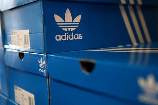 Boxes of Adidas shoes are pictured in the warehouse of local footwear retailer 