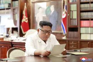North Korean leader Kim Jong Un reads a letter from U.S. President Donald Trump, in Pyongyang