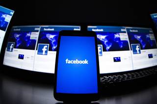 The loading screen of the Facebook application on a mobile phone is seen in this photo illustration taken in Lavigny