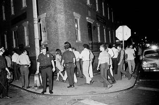 Police officers try to clear a crowd at Seventh Avenue South and Christopher Street, near the Stonewall Inn, in New York.