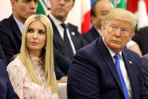 Advisor to the US President Ivanka Trump (L) sits next to her father US President Donald Trump during an event on the theme 